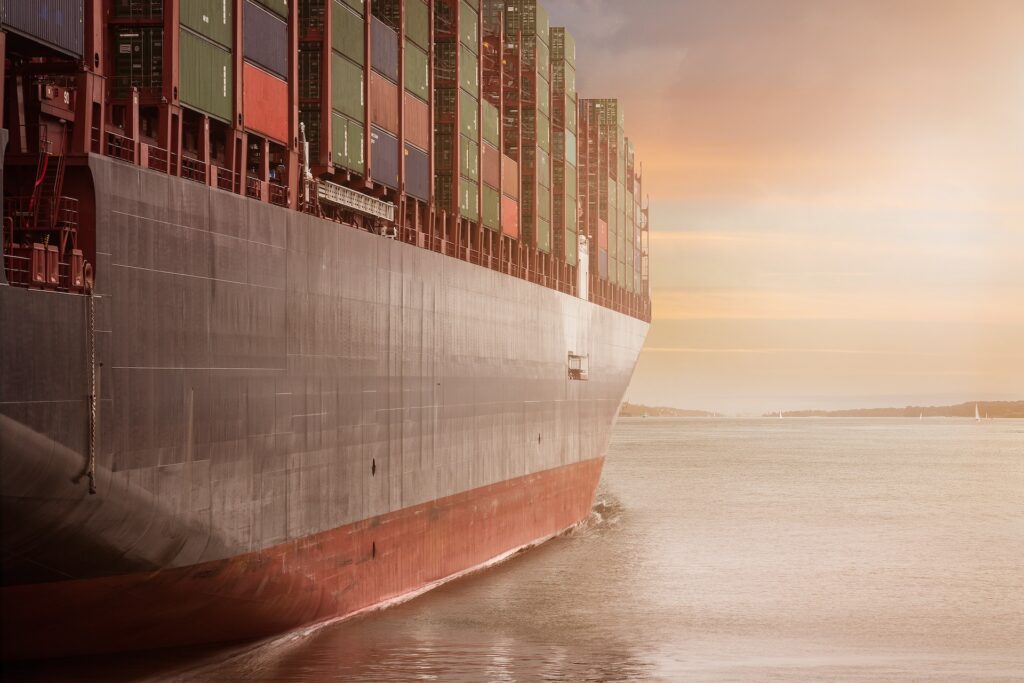 Side view of container Vessel at sunset time - freight forwarding