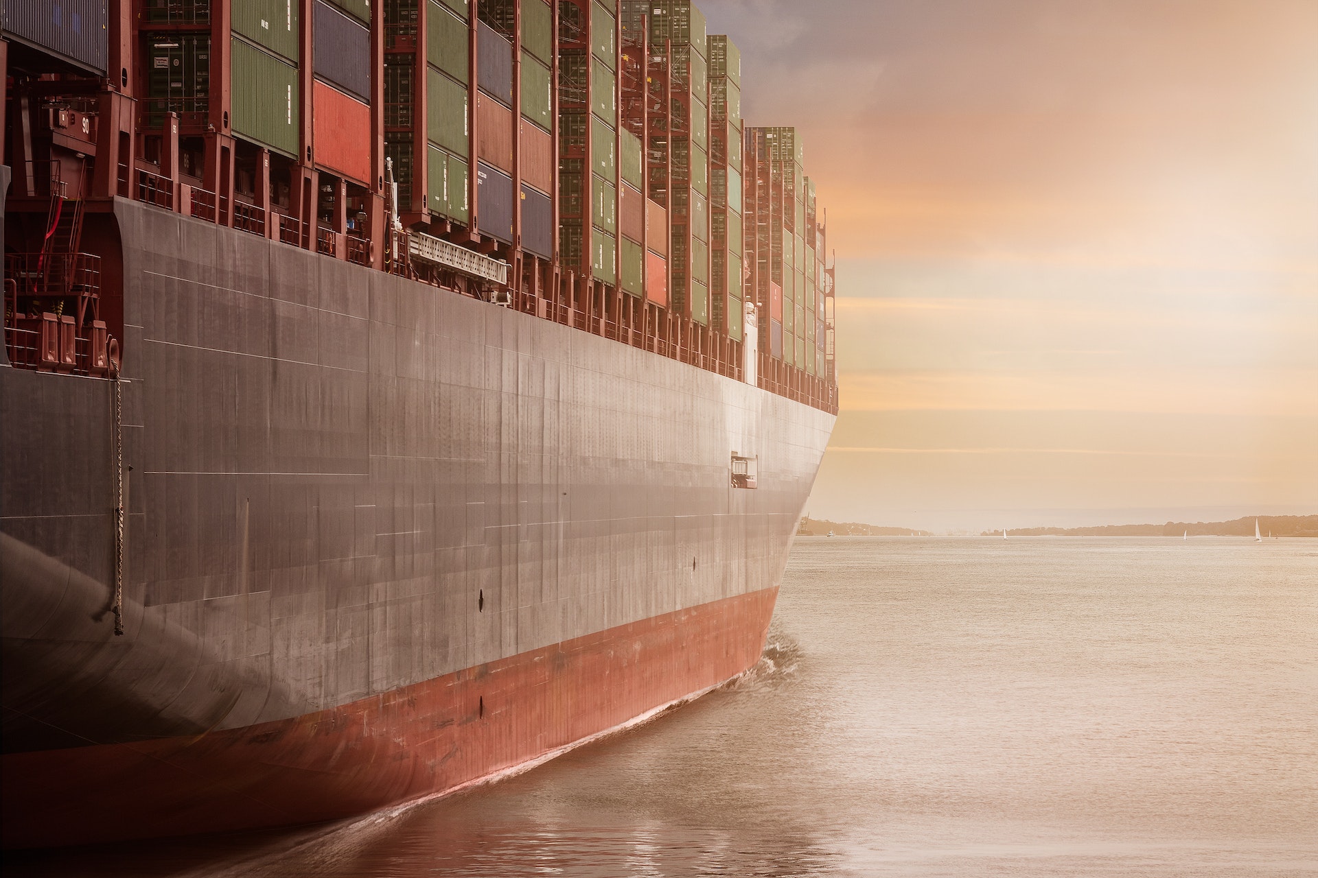 Side view of container Vessel at sunset time - freight forwarding