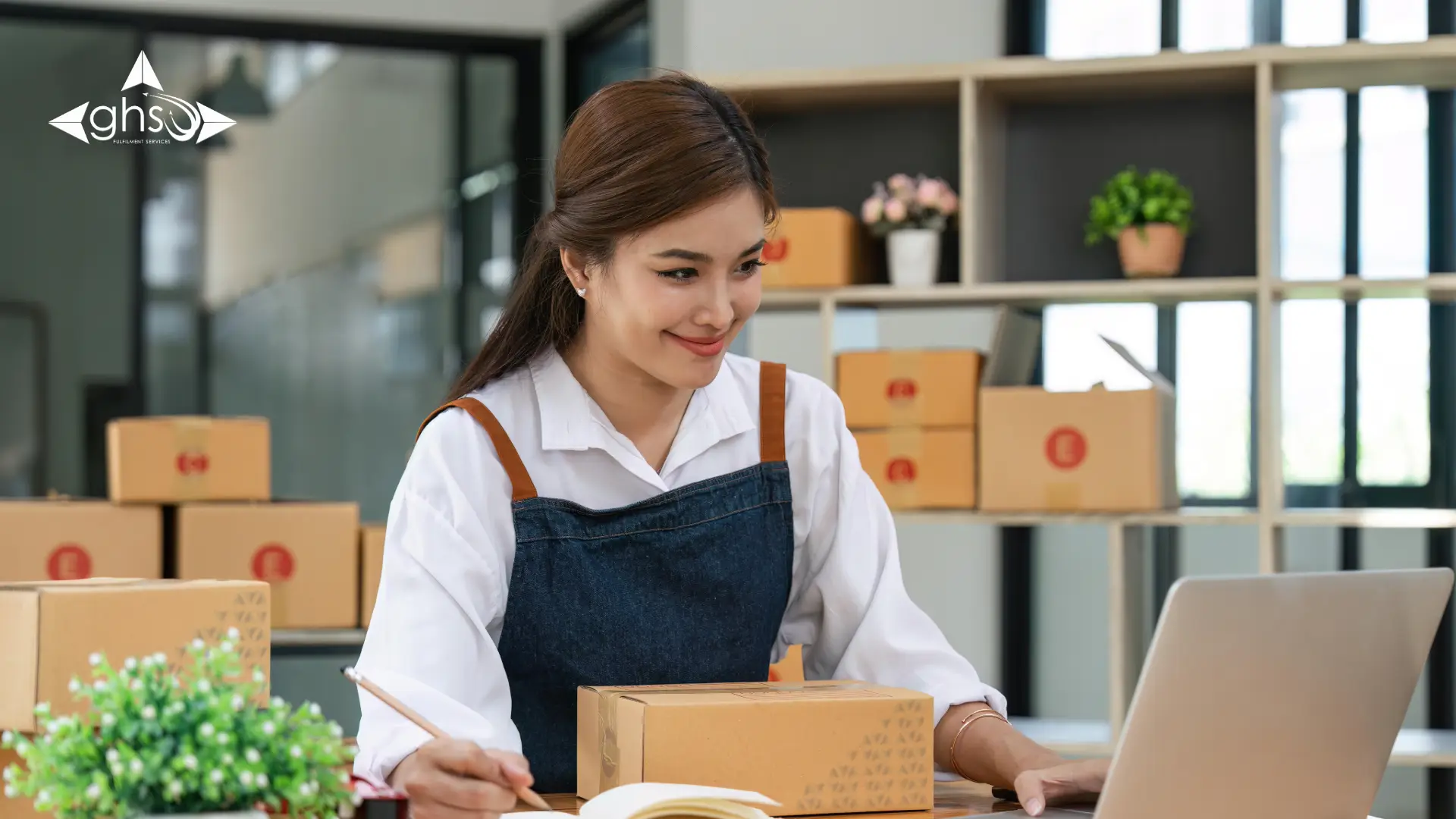 Receptionist preparing set a number of packages to be dispatched for delivery - in-house vs remote fulfilment UAE - by GHSL Fulfilment Centre